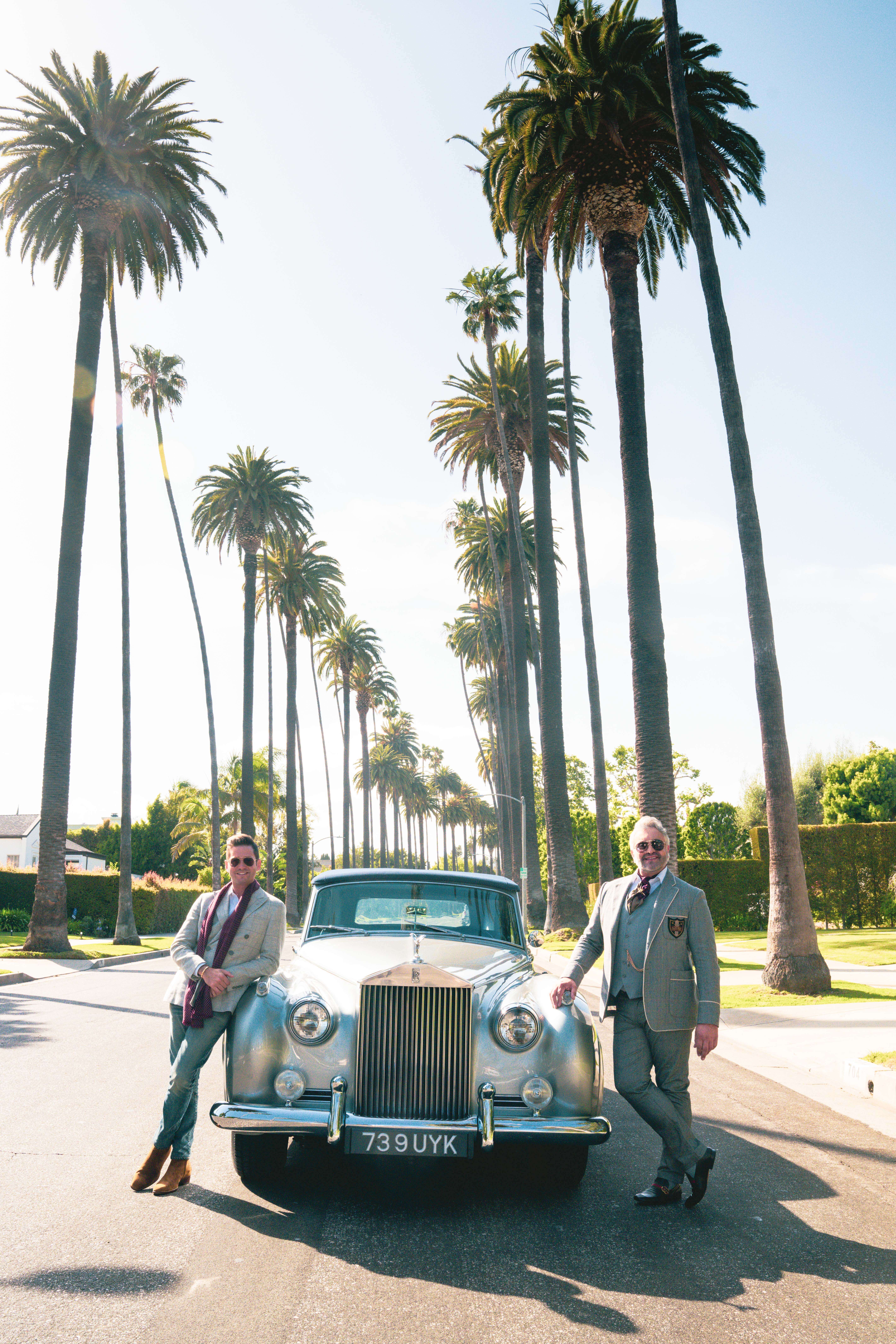 Josh and Martyn pose in the middle ofa palm tree lined street with a vintage car Josh Flagg and Martyn Lawrence Bullard on Bedford drive